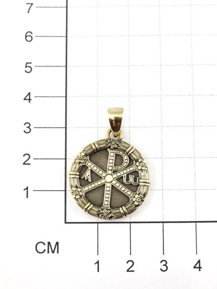 Фотография кулона хризма  монограмма Христа из мельхиора на размерной сетке.
