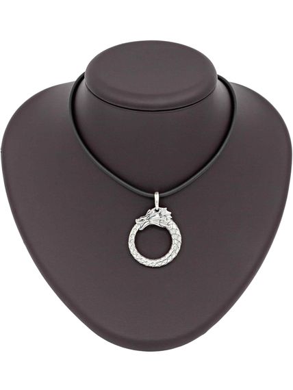 Картинка кулона уроборос без плавника изготовленного из серебра, вид на коричневом постаменте для масштаба.