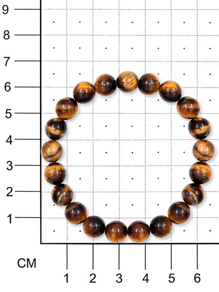 Фото браслета из тигрового глаза 8 мм на белом фоне вид на размерной сетке