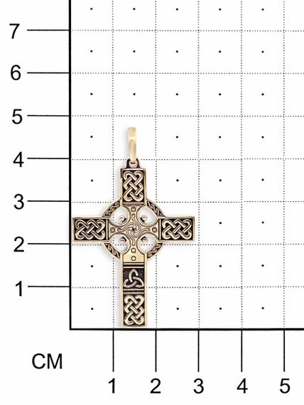Фотография кельтского креста из бронзы на размерной сетке.