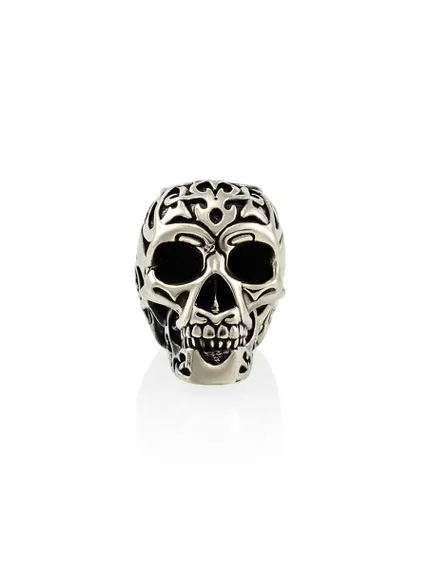 Фото бронзовой бусины череп Tribal skull в профиль на белом фоне.