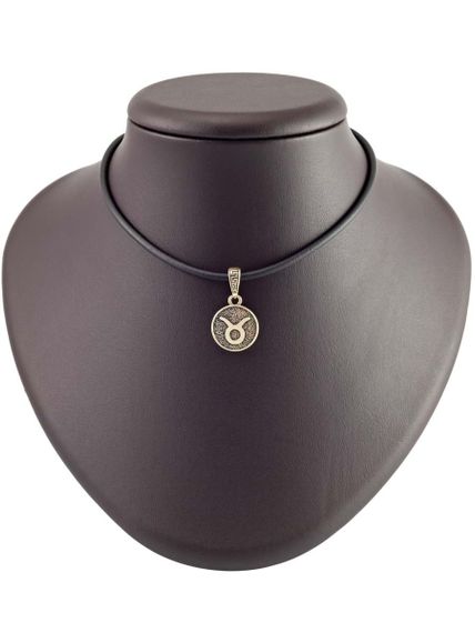 Изображение бронзовой подвески Телец на постаменте.